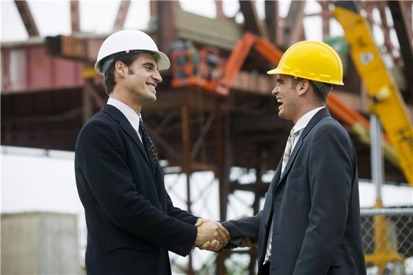 Construction workers shake hands