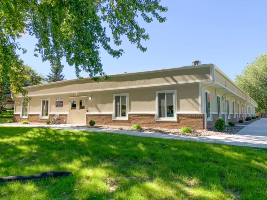 exterior of modular educational building with sidewalk and green grass