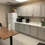 interior of modular educational building teacher lounge with counter table sink and refidgerator