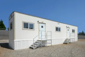 Exterior side view of portable office with two doors and steps