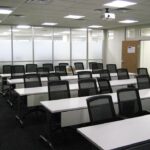 tables and chairs lined up in meeting room