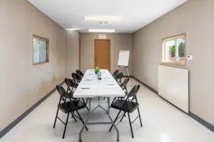 Mobile office interior with a table, chairs, and drawing board