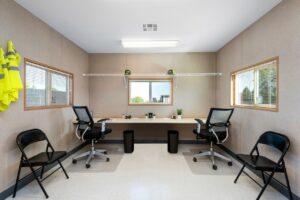 private office with desk and rolling chairs