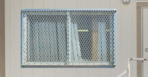 Grated security screen over a mobile office window