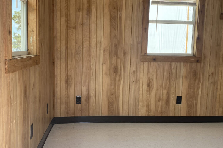 Windows in a private office in a mobile office with wood paneling