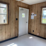 Front entrance to a mobile office with wood paneling