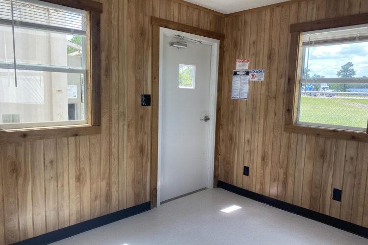 Front entrance to a mobile office with wood paneling