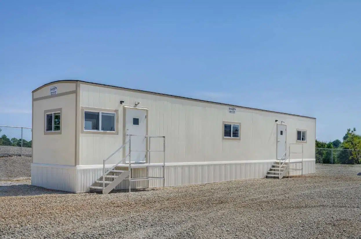 Modular office trailer in a graveled lot.