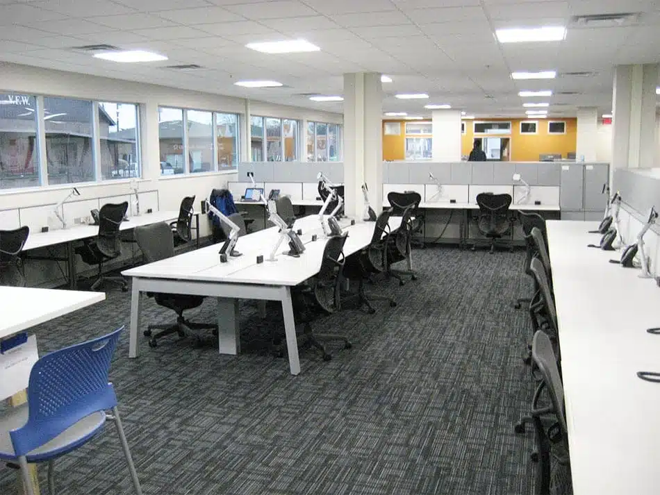 Working space and office desks with multiple chairs inside the Rolls Royce modular office building.