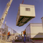 A crane lifting a prefabricated module to its position.