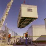 A crane lifting a prefabricated module to its position.