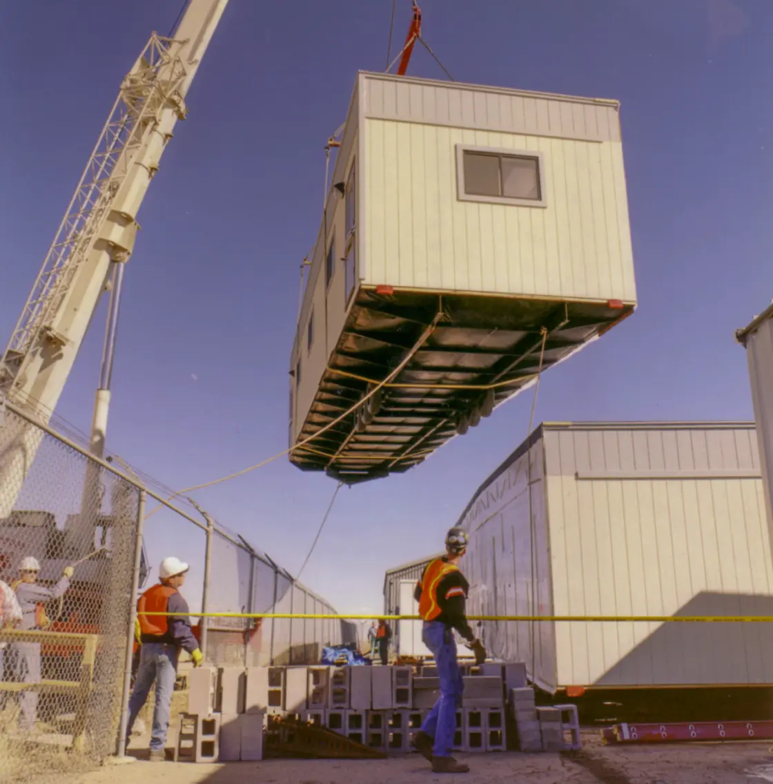 A crane lifting a prefabricated module to its position.