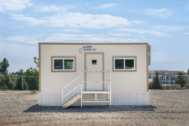 Front view of an 8x24 mobile office with steps leading up to a single door.
