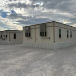 Exterior of a 3-plex modular building and a double wide modular building.