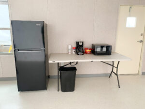 Interior mobile office with café package for a breakroom. Complete with a mini fridge, microwave, and coffee maker.