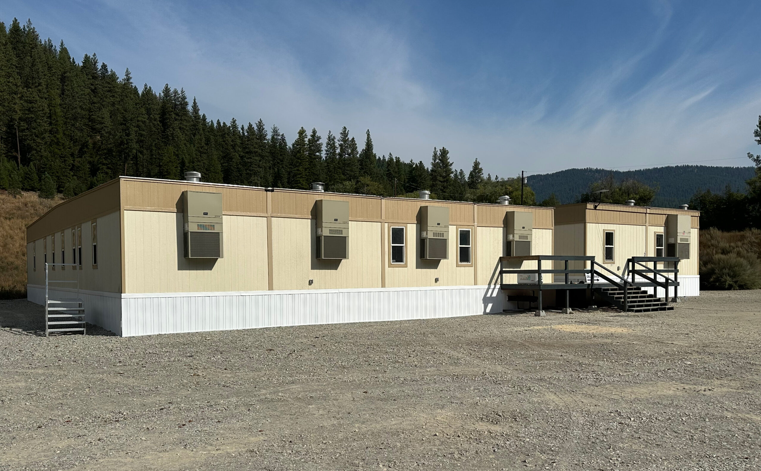 Mobile office on a gravel lot of a construction site.