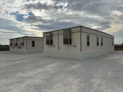 A portable office trailer set up at a construction site.