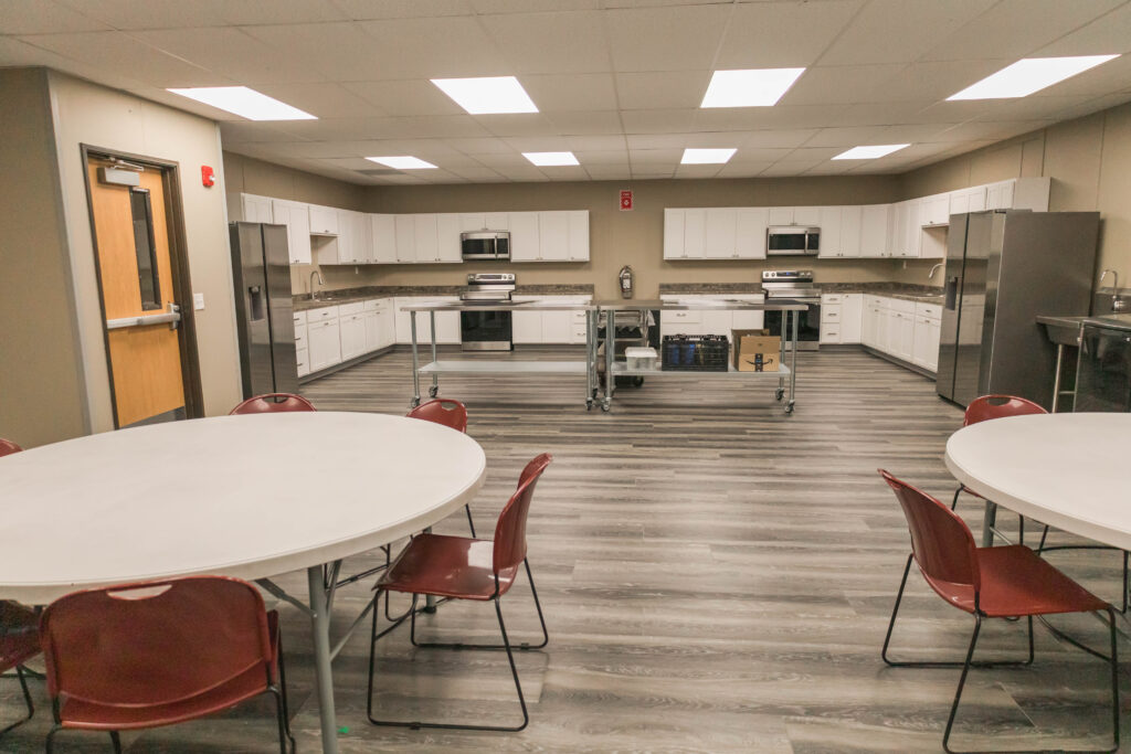 Indoor kitchen with round tables and chairs.