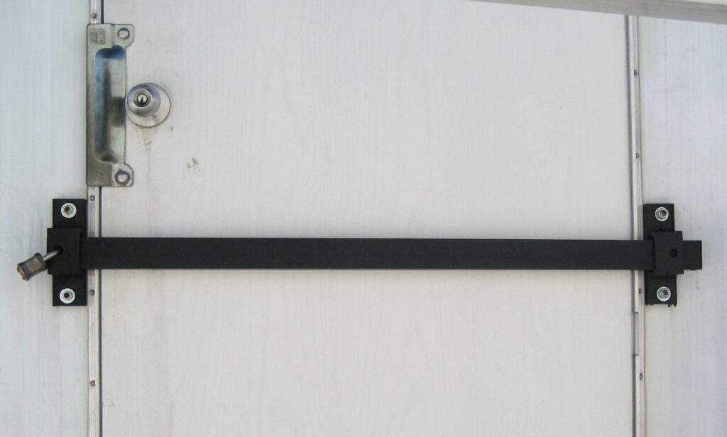A lock bar in front of a door to a mobile office.