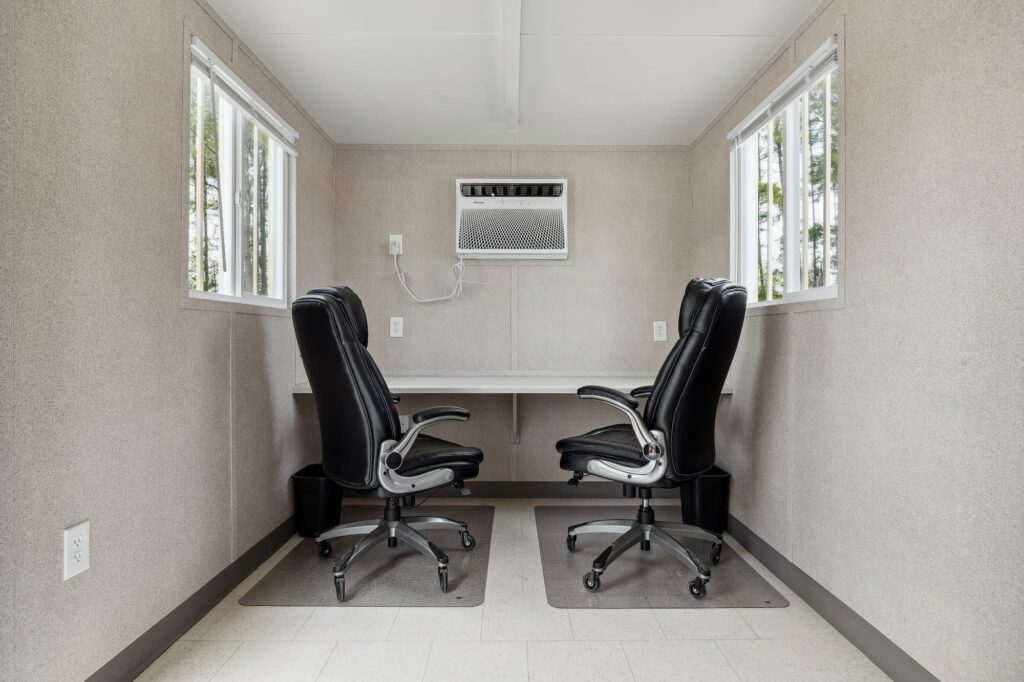Desk chairs and AC unit featured inside a Ground Level Office (GLO)