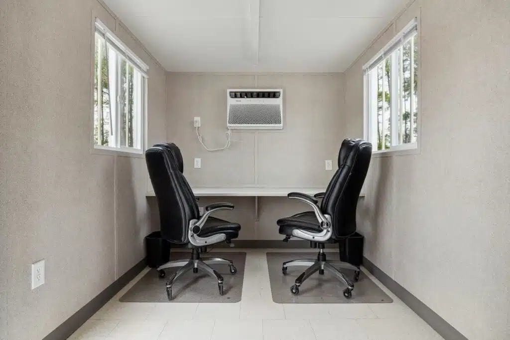 Desk chairs and AC unit featured inside a Ground Level Office (GLO)