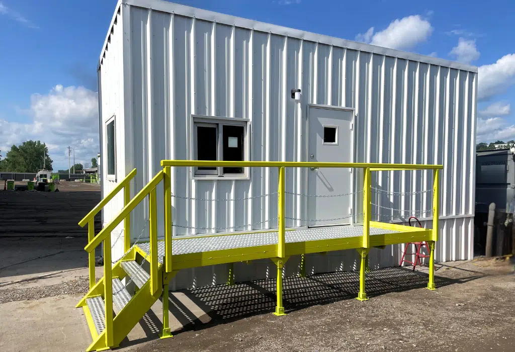 Custom 8×24 skidded office trailer installed next to the truck scale, giving operators a dedicated workspace without expanding the facility footprint.