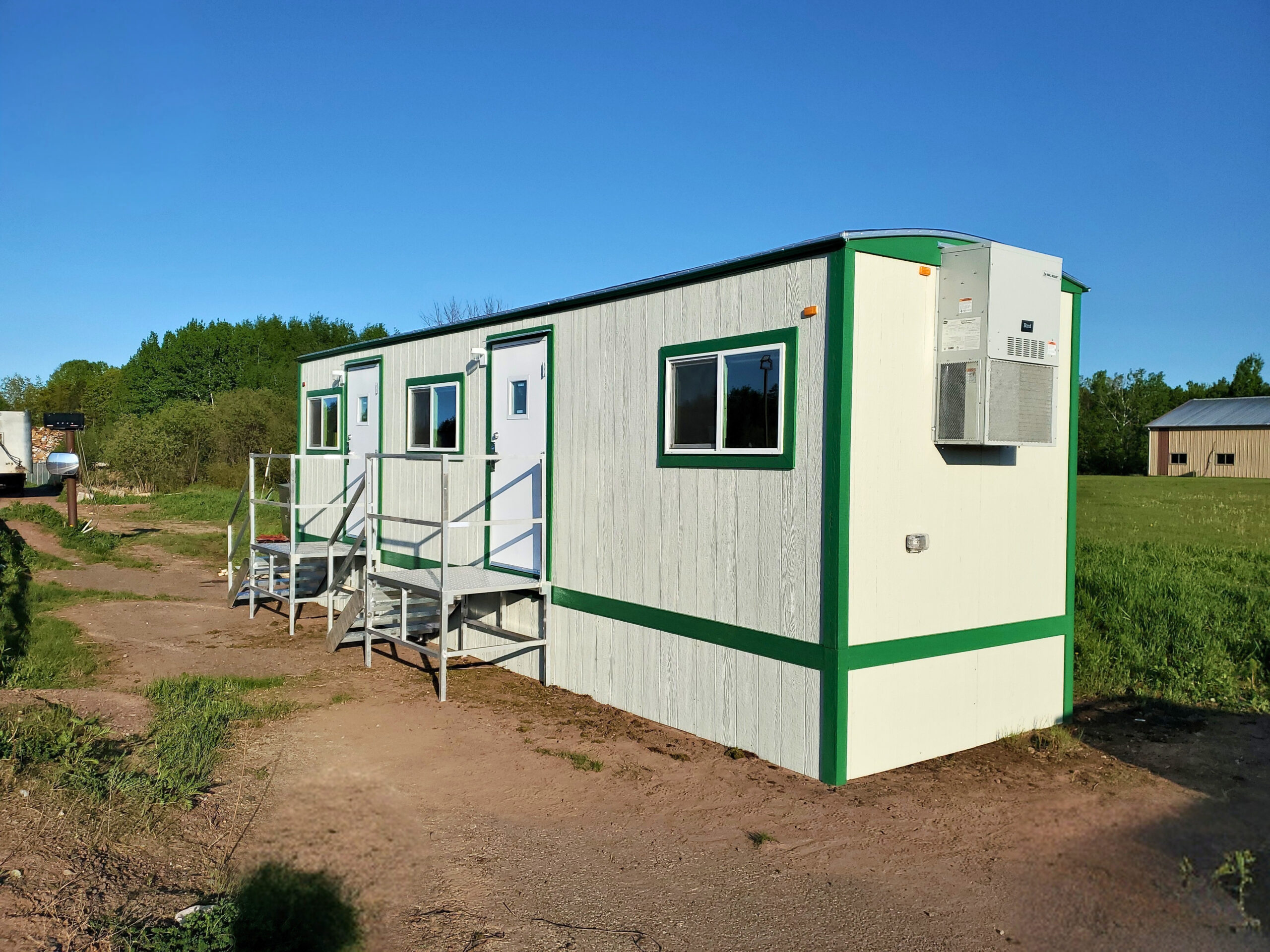 Custom modular scale house installed on site with HVAC system and branded exterior colors designed to match the customer's facility.