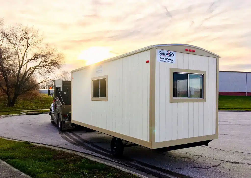 Construction office trailer on a hitch outside.