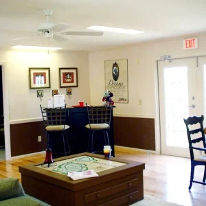 reception office with wood floors table and seating areas