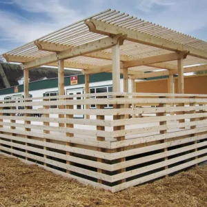 deck and pergola attached to green and white modular building