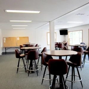 group of hi top tables and chairs in open room